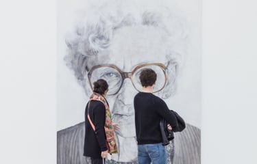 A woman and a man looking at a drawing.