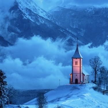 Small church in mountains.